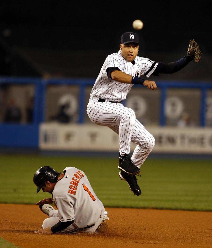  Yankees captain Derek Jeter leaps over Baltimore’s Brian Roberts to turn a double play. (Paul J. Bereswill/MCT)