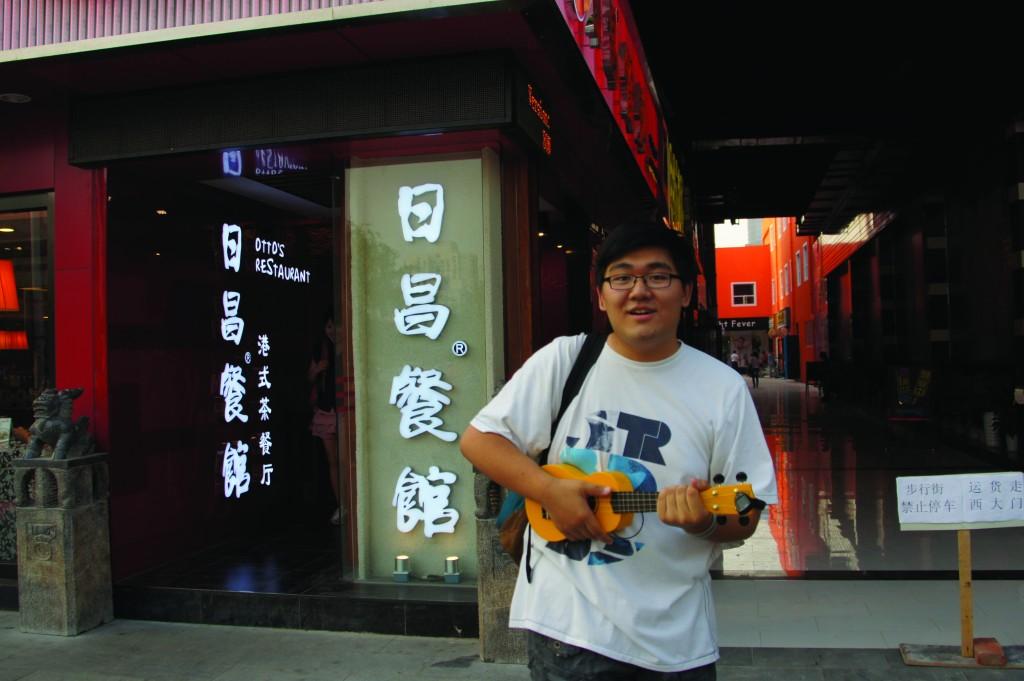 Tavy Wu, FCLC ’16, poses with his ukelele in front of a restaurant in his native China.  (Photo courtesy of Tavy Wu)
