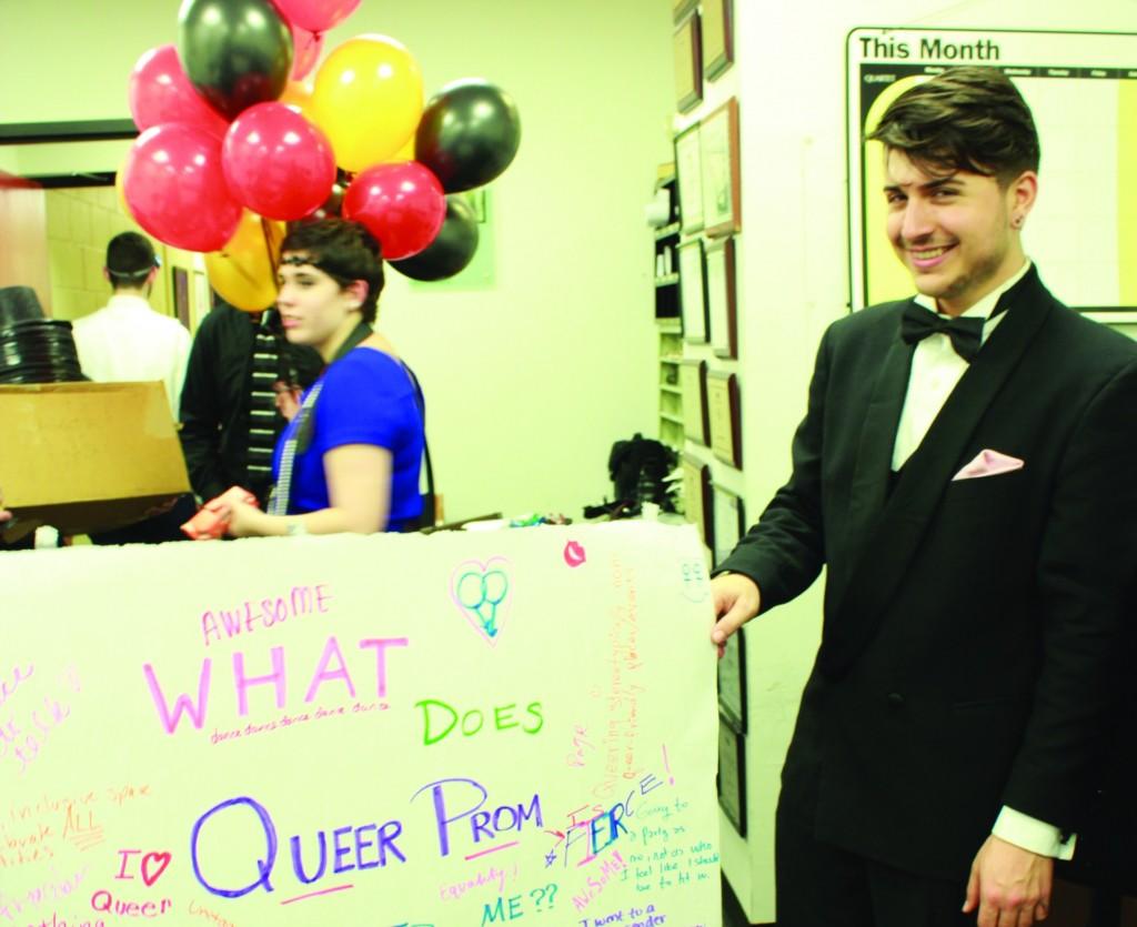 Charlie Martin, FCLC ’14, president of Rainbow Alliance holds a meaningful sign for Queer Prom attendees. (Ayer Chan/The Observer)