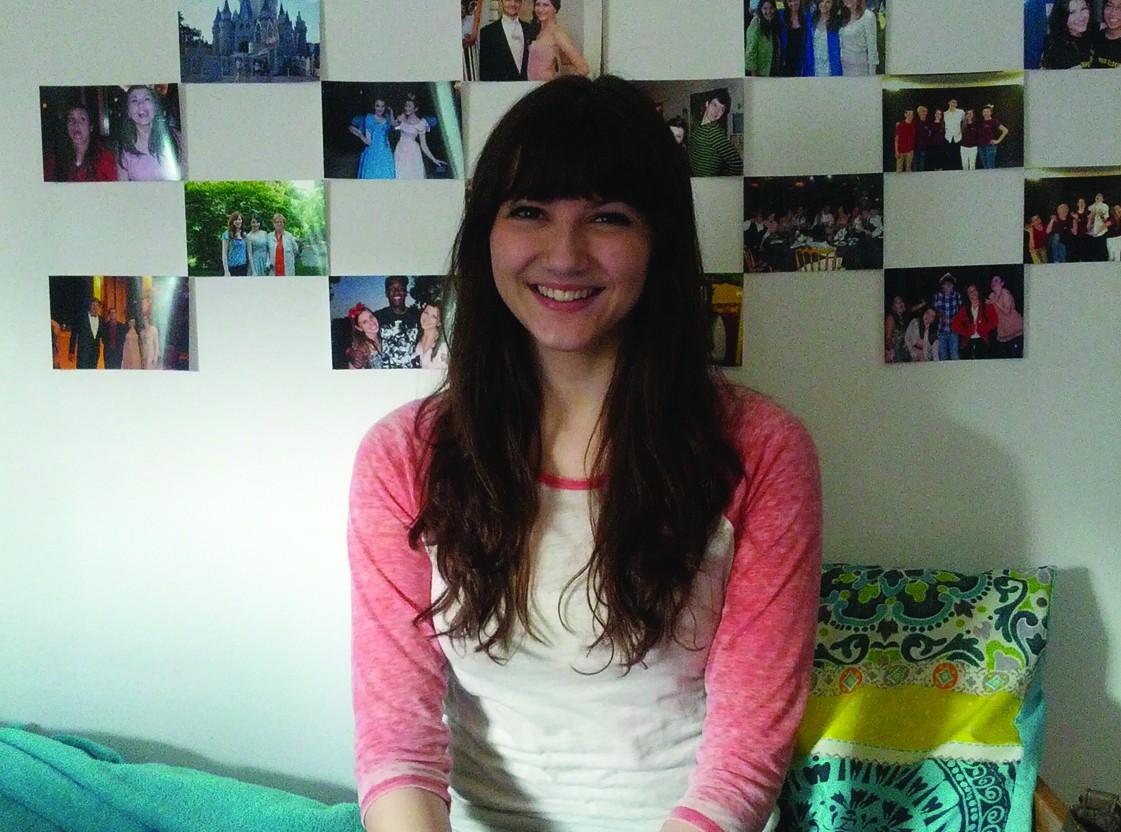 Alexandra Vittorini, FCLC ’15, smiles in her newly decorated dorm room. (Sherry Yuan/The Observer)