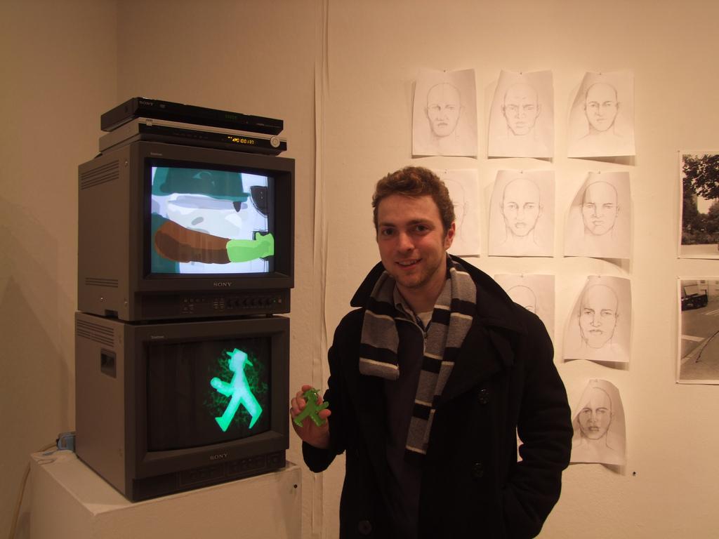Tim Leuke, FCLC 13, with his work in the senior exhibition in the main gallery. (Ludovica Martella/The Observer)
