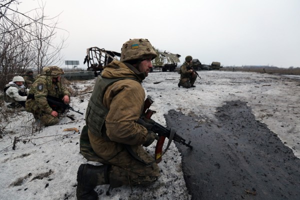 Ukrainian soldiers gathering in front of a destroyed convoy of pro-Russia separatists. (Courtesy of Sergei L. Loiko/Los Angeles Times via TNS)