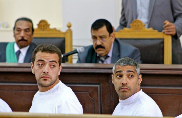 Cameraman Baher Mohamed, left, and Mohamed Fadel Fahmy, the Cairo bureau chief for al Jazeera English, look at reporters sitting behind them Monday, March 31, 2014, as Judge Mohamed Nagy listens to the defendants complaints about the conditions they are being held in. Three Al Jazeera journalists, including Australian Peter Greste (not pictured) are standing trial on terror charges. (PHOTO COURTESY OF AMINA ISMAIL/ TNS)