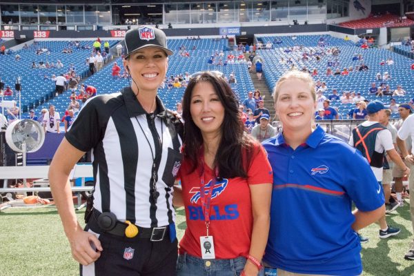 Kathyrn Smith (right) pictured with referee Sarah Thomas and Bills owner Kim Pegula before their historic game in August. (COURTESY OF KIM PEGULA/TWITTER)
