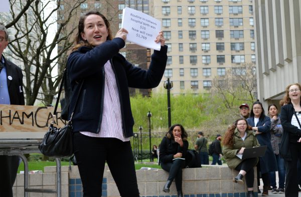 Assistant Professor of Comparative Literature Shonnie Enelow holds up a sign during the protest on April 19. (ELIZABETH LANDRY/The Observer)