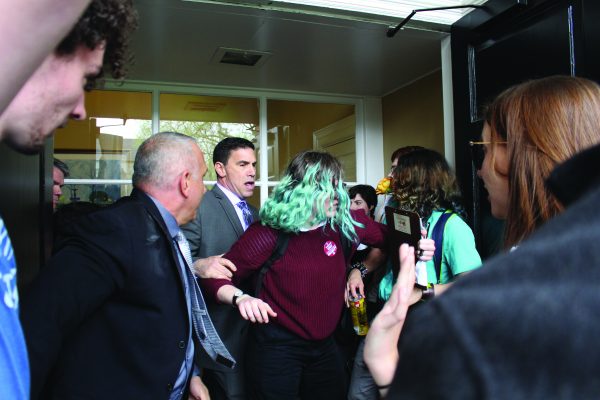 Student protester Sapphira Lurie, FCLC 17, is blocked from entering a door by Public Safety supervisors at Cunniffe House at Fordham Rose Hill. (GEORGE HORIHAN/The Observer)