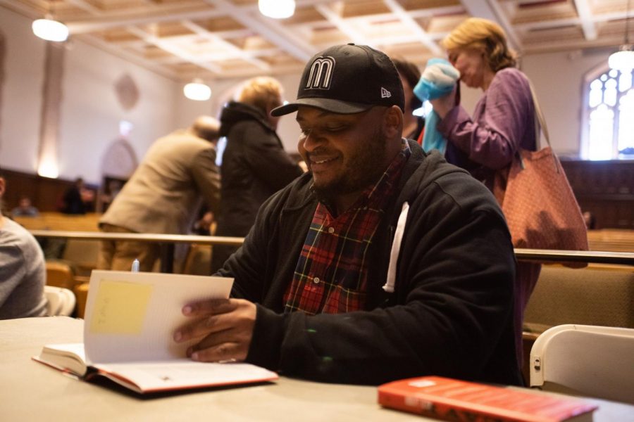 Kiese Laymon signs Fordham students copies of his memoir, Heavy.