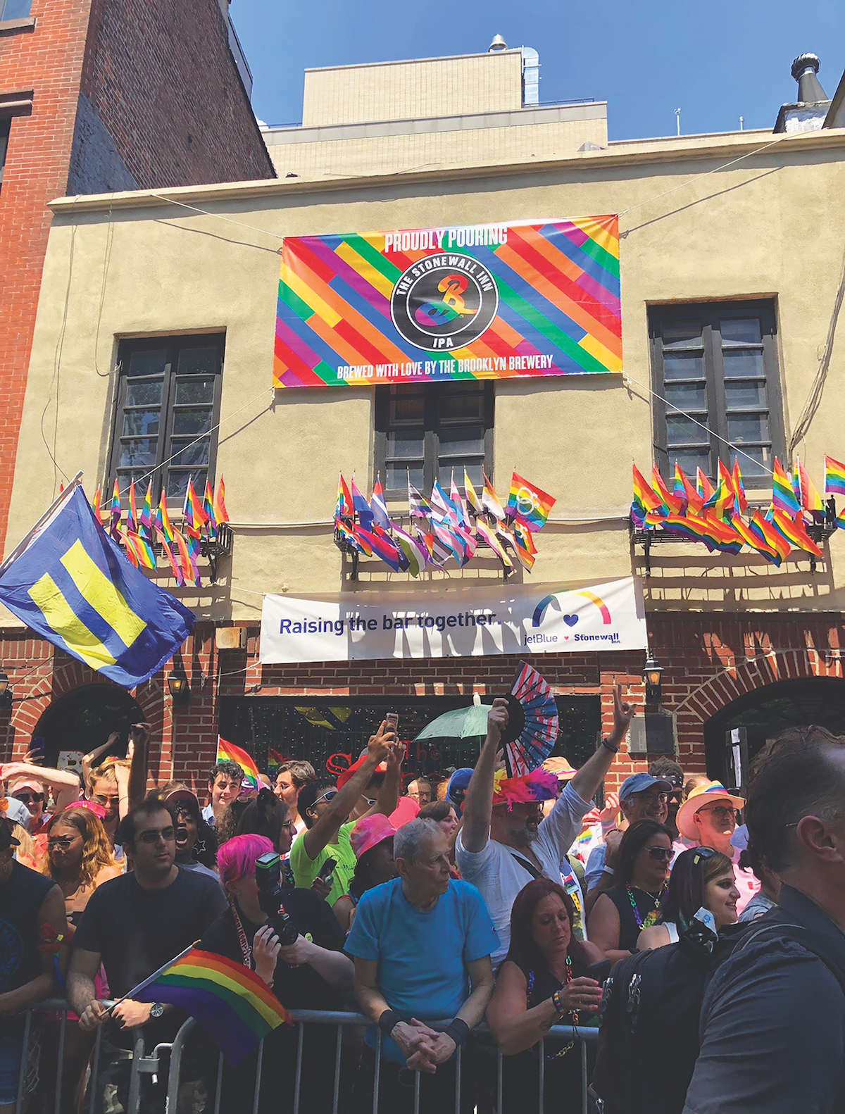 Pride participants celebrating outside of The Stonewall Inn, where the modern gay rights movement began in 1969.