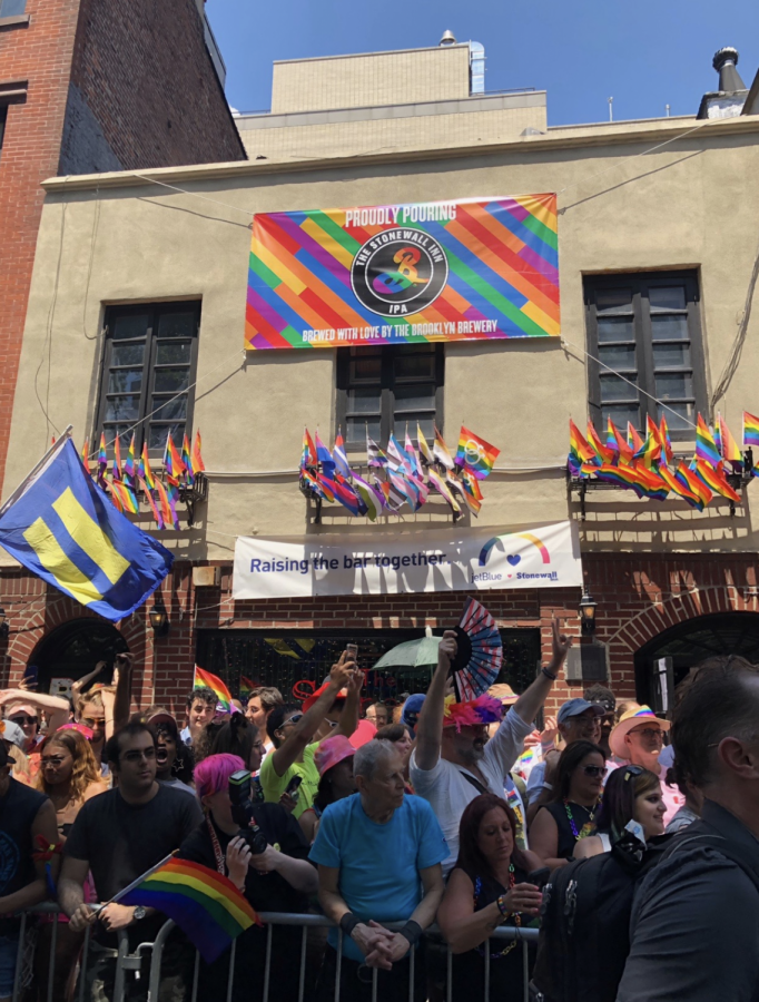 Pride participants celebrating outside of The Stonewall Inn, where the modern gay rights movement began in 1969.