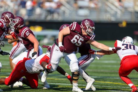 Offensive lineman Ryan Joyce, Fordham College at Rose Hill (FCRH) ‘23, blocks for quarterback Tim DeMorat, FCRH ‘22 against Richmond defenders.