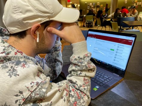 A student stares confused at the Fordham E-Bill Suite
