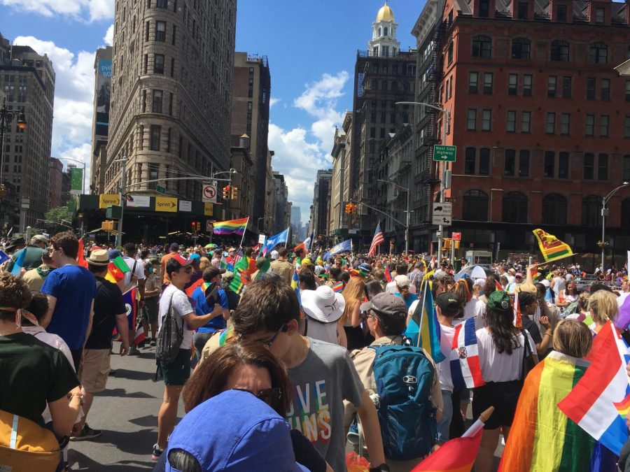 A+colorful+celebration+in+the+streets+of+New+York+City+during+Pride+March+2019.+Flags+from+all+over+the+world+can+be+seen.