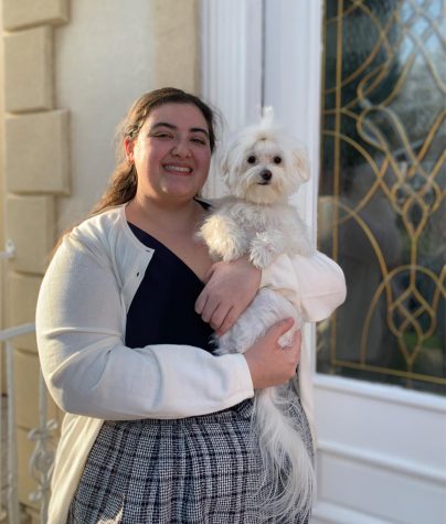 girl dressed up holding a dog