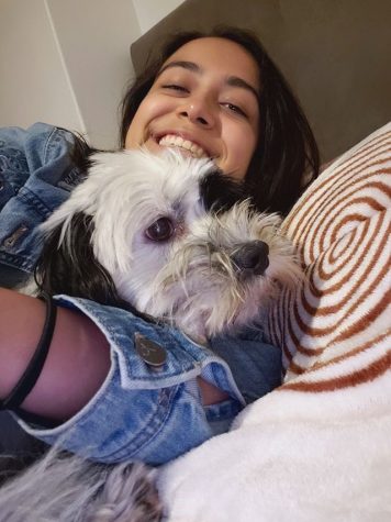 girl cuddling with dog