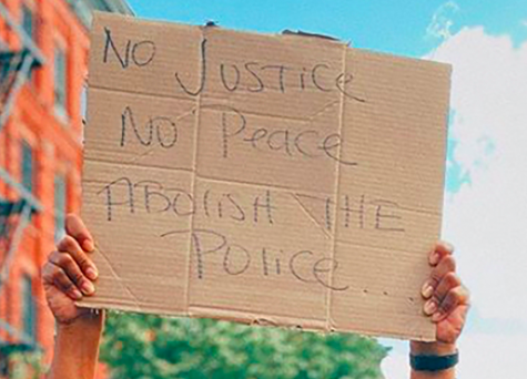 sign that says "no justice, no peace, abolish the police"