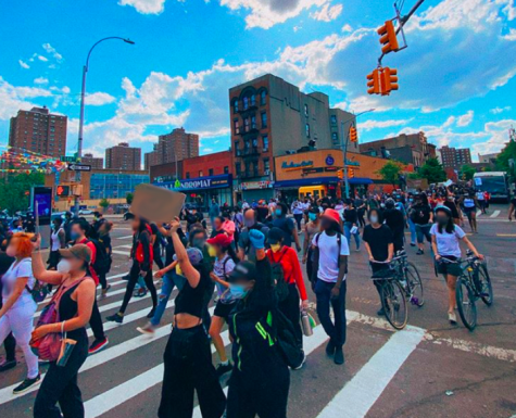 protestors marching down a city street