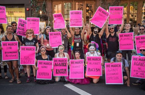 attendees holding up posters at the Queer Liberation March