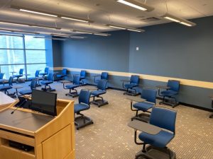 A classroom in the Gabelli school with chairs sparsely populating the room