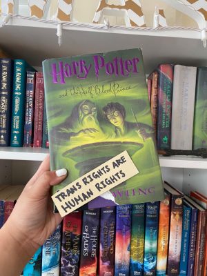 Harry Potter Book with a sticker that says trans rights are human rights on top