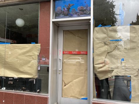 the outside of Fluffy's restaurant with brown paper in the windows and doors