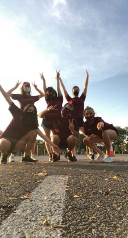 group of students in maroon shirts and masks at orientation