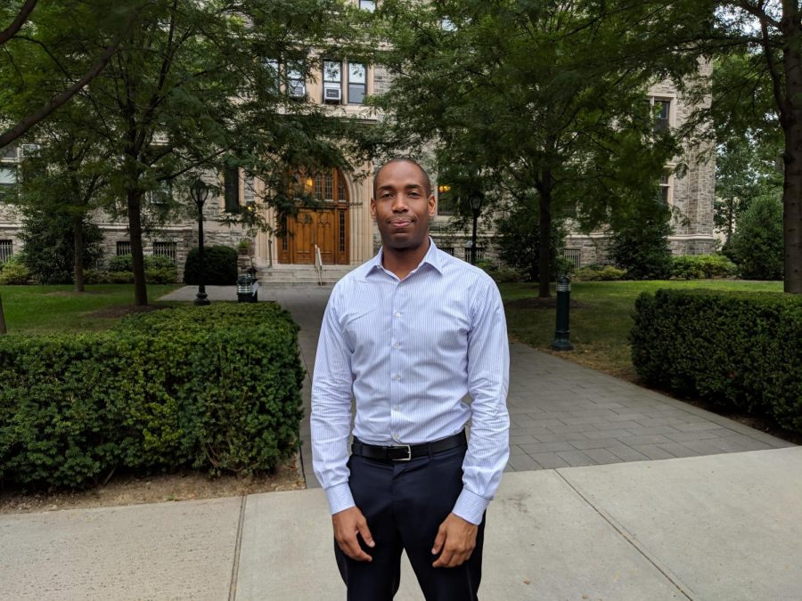 a photo of Title IX coordinator Kareem Peat taken with the Rose Hill campus in the background