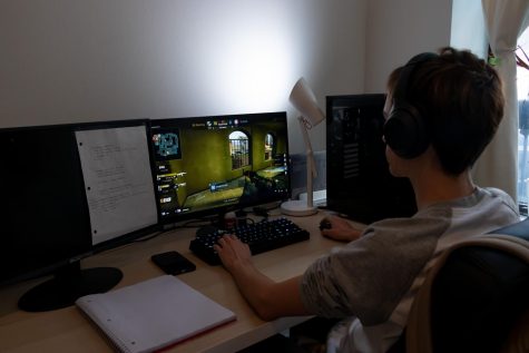 boy sitting at computer playing eSports