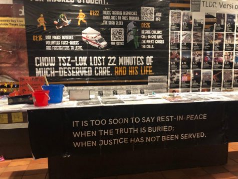 a memorial with a banner reading "it is too soon to say rest in peace when the truth is buried. when justice has not been served." above is a sign reading "chow tsz-lok lost 22 minutes of much-deserved care. and his life."