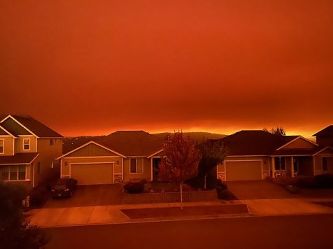 a red sky in oregon above suburban houses, which fuels concerns about climate change