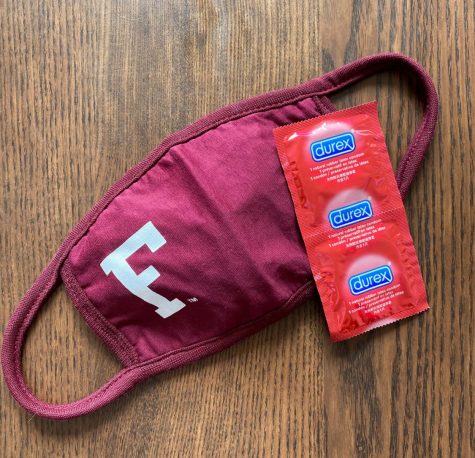 maroon mask with fordham F on it next to red condoms - sex in a pandemic