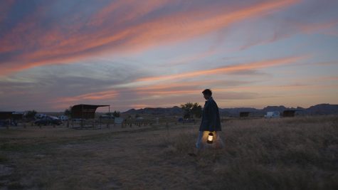 Woman walking at dusk with lamp