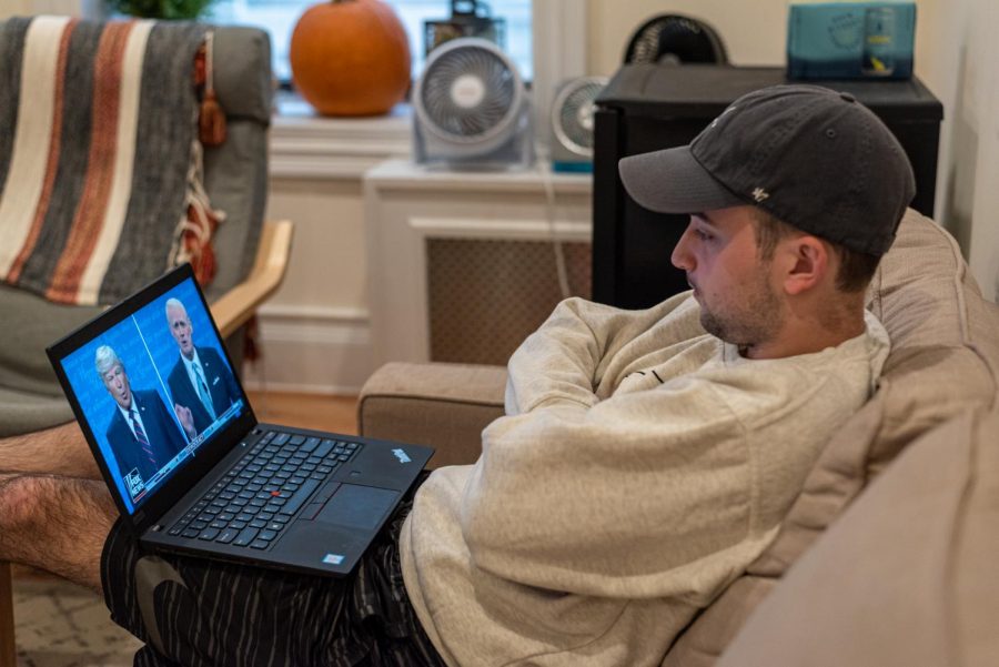 A young man watched Saturday Night Live on his laptop