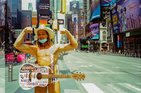 Naked Cowboy stands with guitar in front of empty Times Square