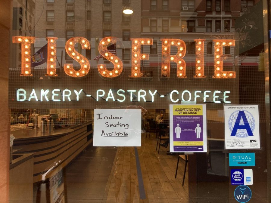 shop window with the words tisserie - bakery - pastry - coffee and a sign saying  indoor seating available