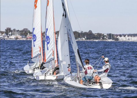 photo of sailboat on the water with two members of the intramural sailing team in it