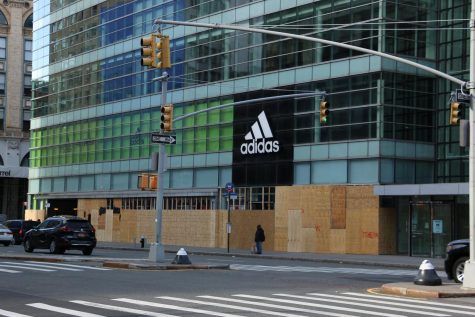 the Adidas store with its first floor windows entirely covered with boards
