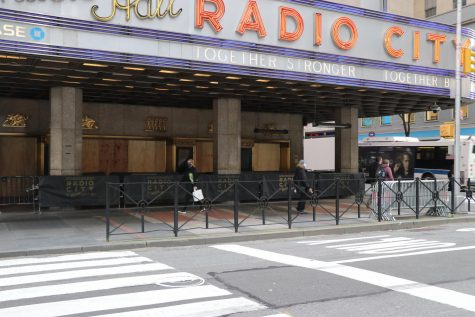 Radio City Music Hall seen from the street with boards on the windows