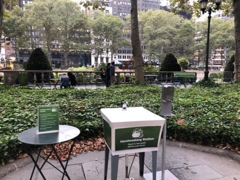 handwashing station in the middle of one of bryant park's stone-tiled spaces