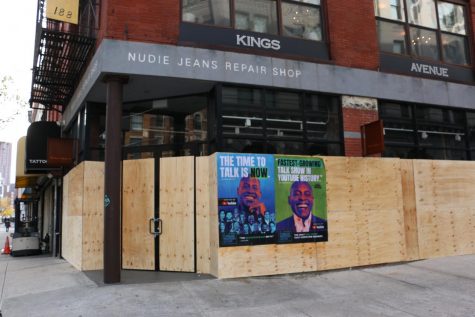 the Nudie Jeans Repair Shop with boards on the windows and posters advertising a Youtube show put up