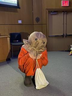 Someone squatting in a Trick ‘r Treat Sam costume.