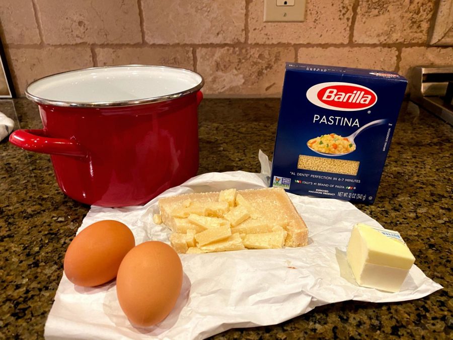 Ingredients for pastina con le uovo are laid out on a rag with a red pot