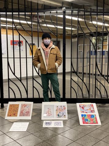 Antonio Garcia stands with his art display in a subway station