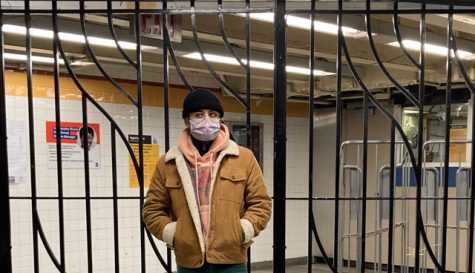 Antonio Garcia stands with his art display in a subway station
