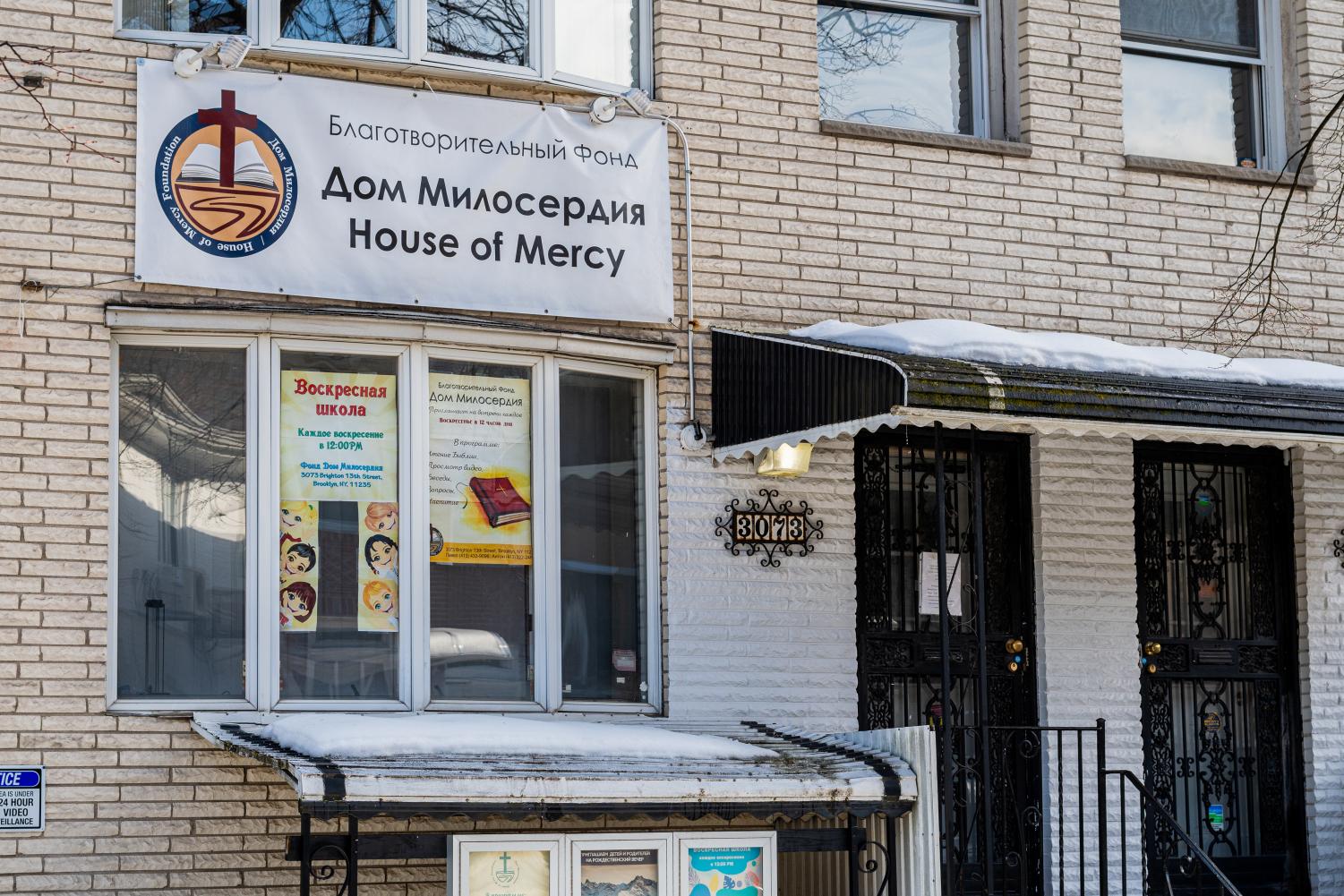 front of a church in little odessa with a sign that reads "house of mercy" in english and russian