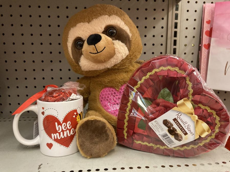 stuffed sloth, mug with a heart on it and box of chocolate