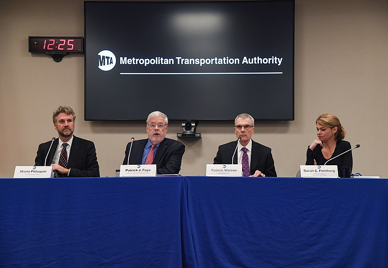 four people sitting at a table for a press conference on the MTA
