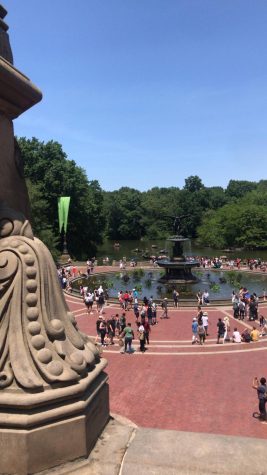 People walking around Bethesda Fountain on a nice day
