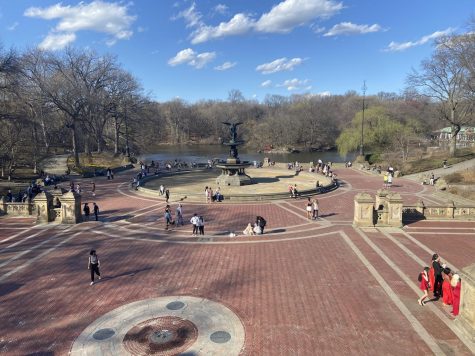 Photo of people walking around bethesda fountain on a sunny day in Central Park