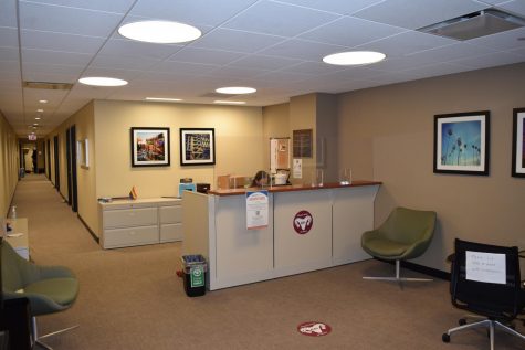 for an article about mental health, the office of counseling at fordham, with a person sitting at a front desk in a beige room
