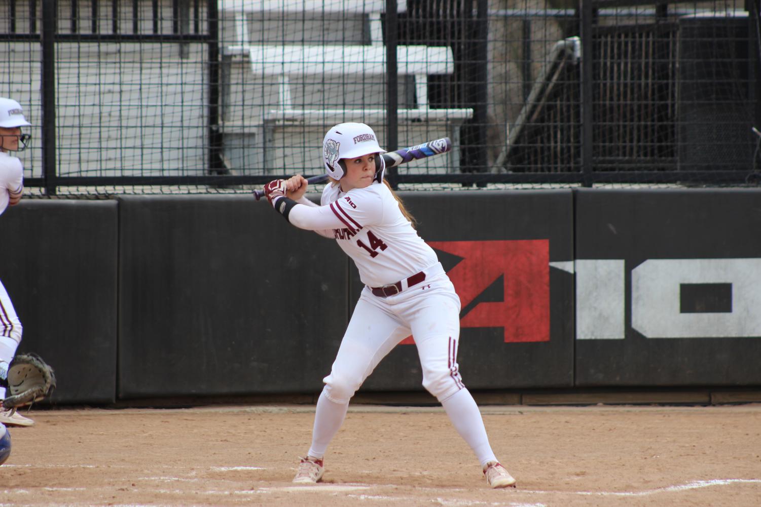 girl holding a bat in game against seton hall